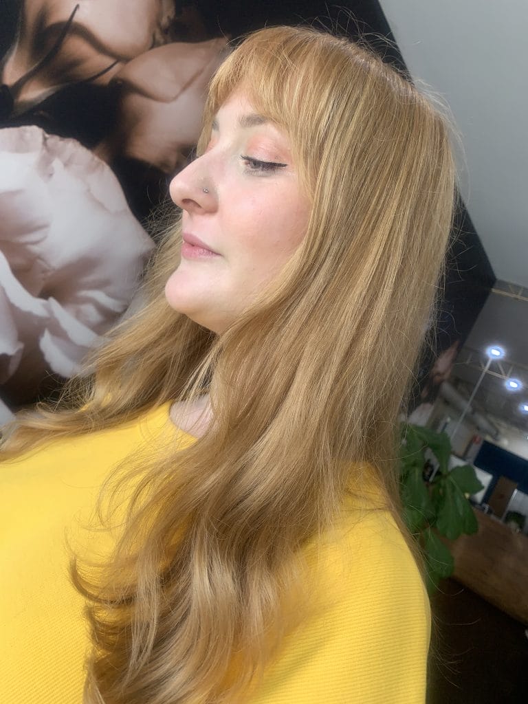 "Get ready to turn heads with this stunning warm blonde hair color and wispy curtain fringe that perfectly frames the face. Located in the trendy St Kilda area of Melbourne, this hairstyle is sure to make a statement and enhance your natural beauty."